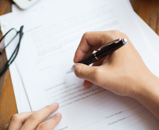 Unrecognizable man filling application form. Businessman checking papers. He signing document. Manager working with report. Financial report concept